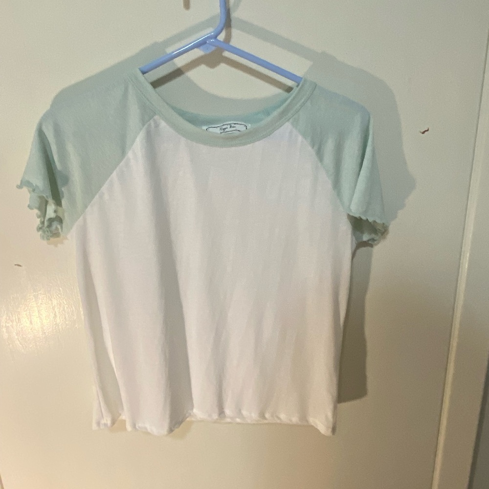 A Hippie Rose t-shirt with teal colored sleeves.